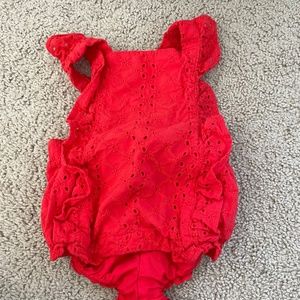 Bright red body suit